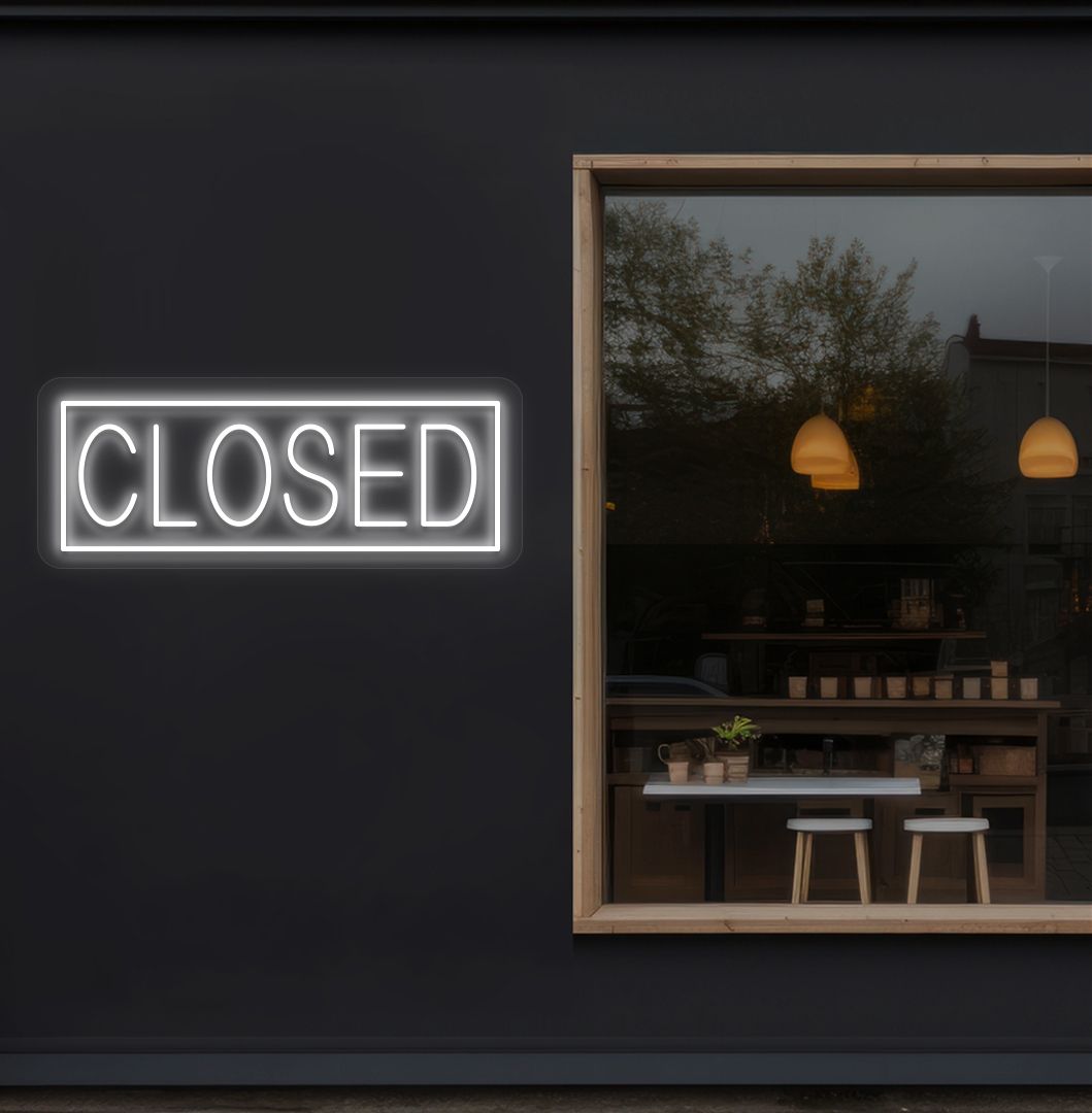 Image of a closed neon sign glowing on shop exterior wall in white color.