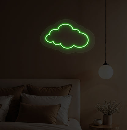 A green cloud LED neon sign hanging on a bedroom wall for kids' room decor.