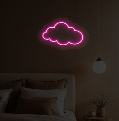 A pink cloud LED neon sign hanging on a bedroom wall for kids' room decor.