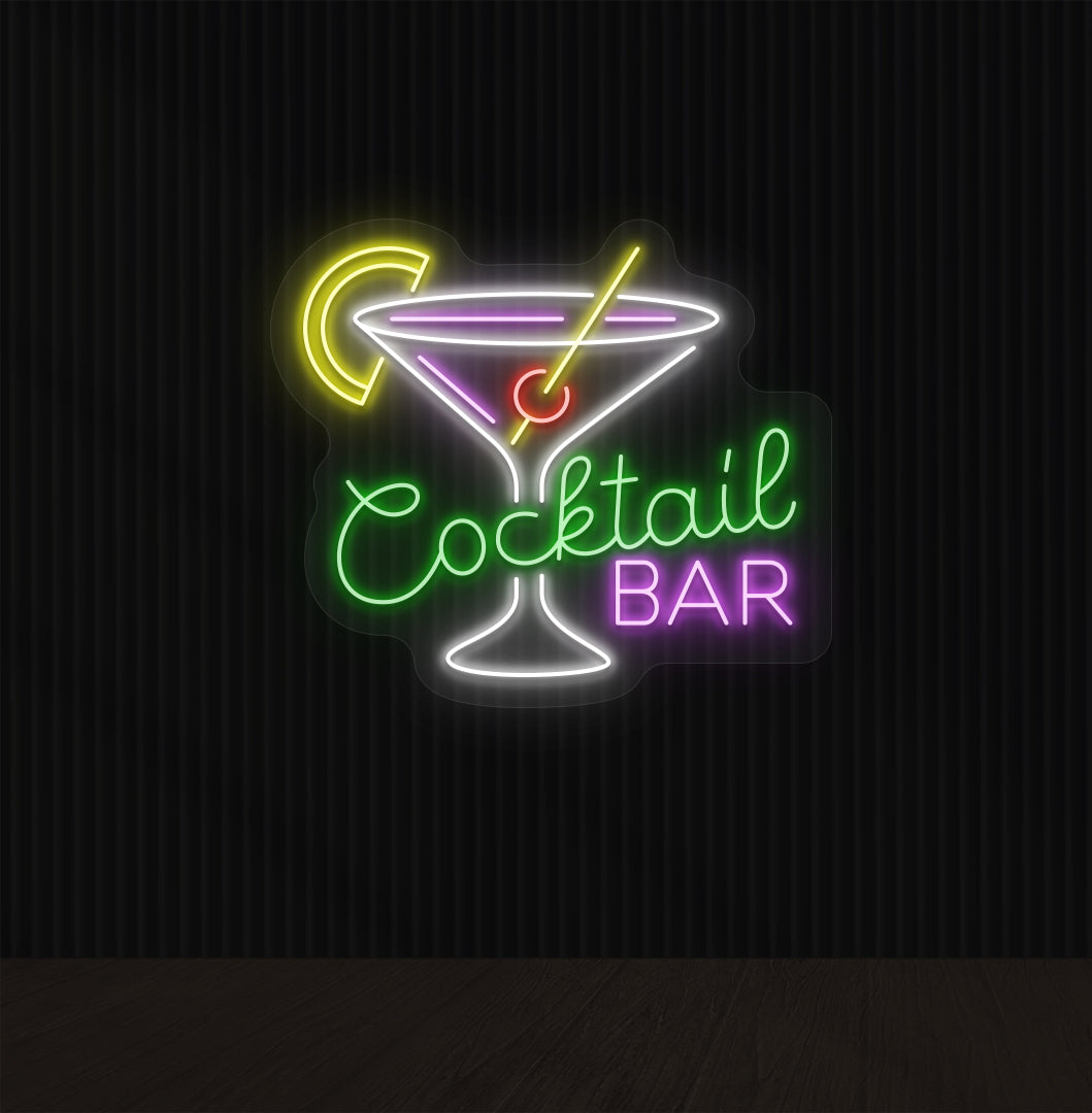 A cocktail bar neon sign with a cocktail glass, straw, and lemon glowing in the middle of the design in green light.