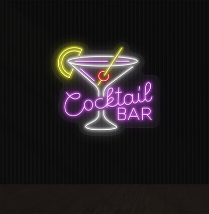 A cocktail bar neon sign with a cocktail glass, straw, and lemon glowing in the middle of the design in purple light.