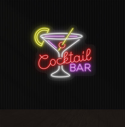 Image of a red cocktail bar neon sign mounted on a wall with a martini glass, straw, and strawberry.