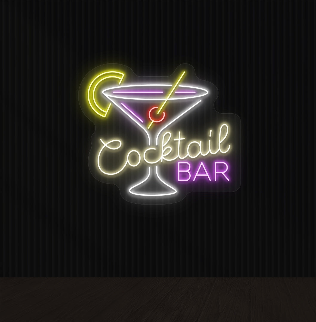 A cocktail bar neon sign with a cocktail glass, straw, and lemon glowing in the middle of the design in warm white light.