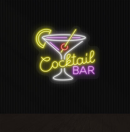 Image of a yellow cocktail bar neon sign mounted on a wall with a martini glass, straw, and strawberry.