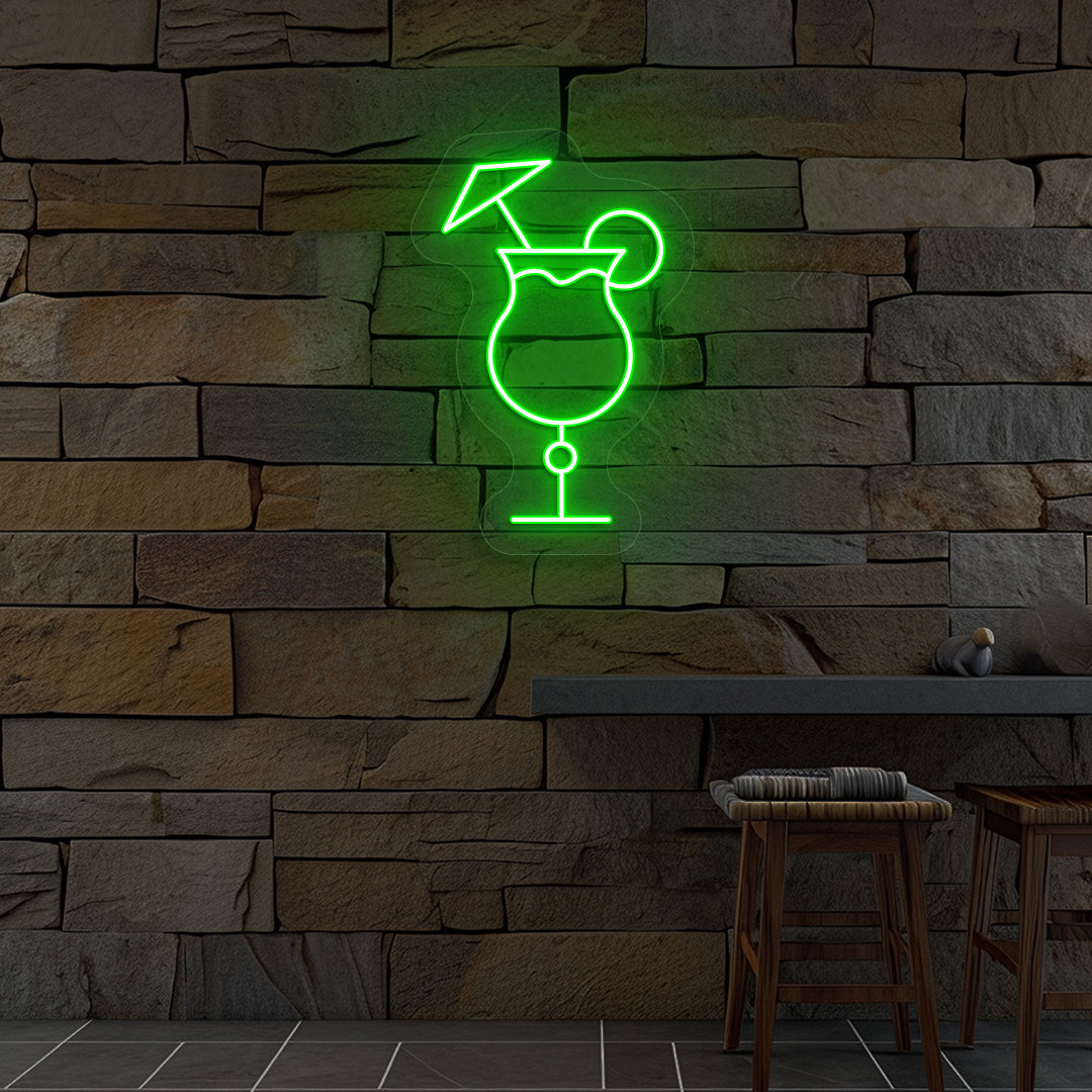 Stylish "cocktail glass with a lime" neon sign glowing green on wall.