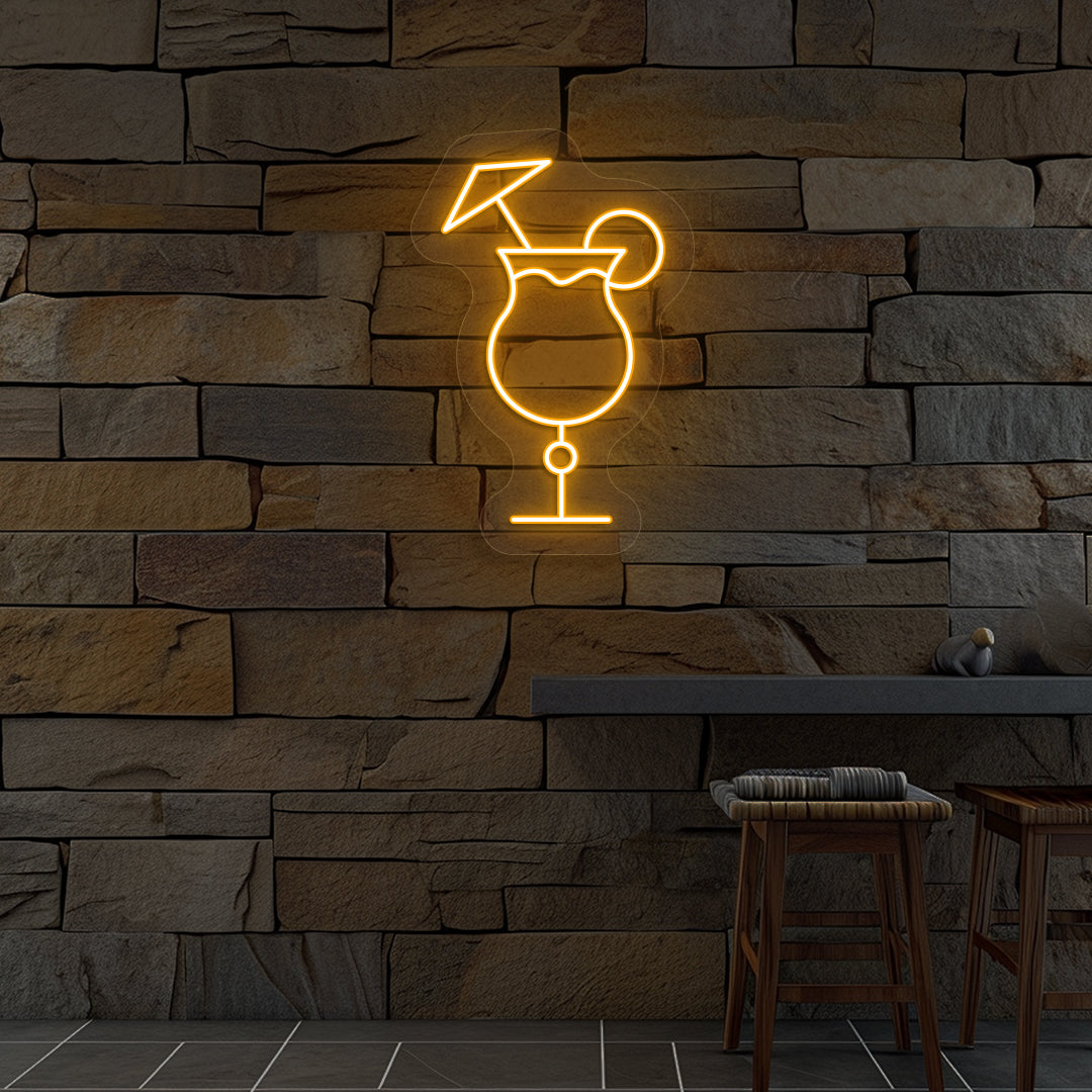 Stylish "cocktail glass with a lime" neon sign glowing orange on wall.