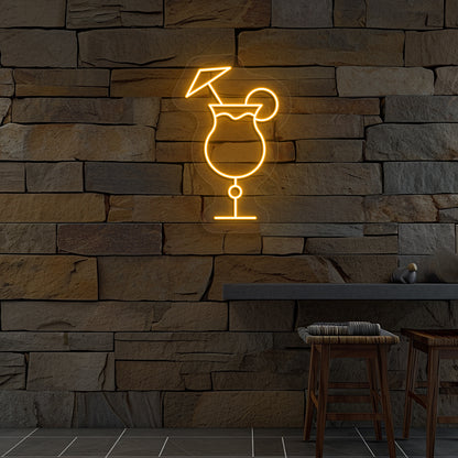 Stylish "cocktail glass with a lime" neon sign glowing orange on wall.