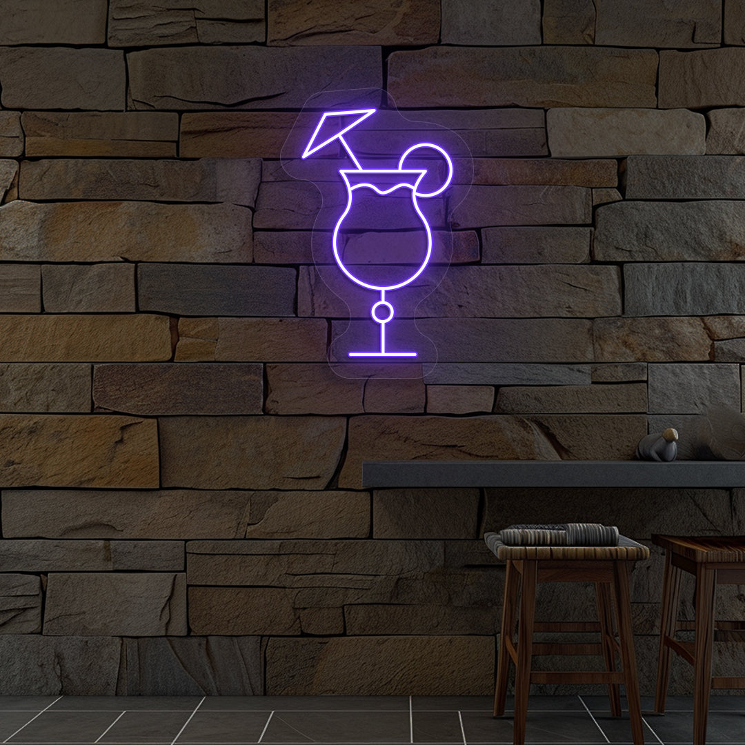 Stylish "cocktail glass with a lime" neon sign glowing purple on wall.
