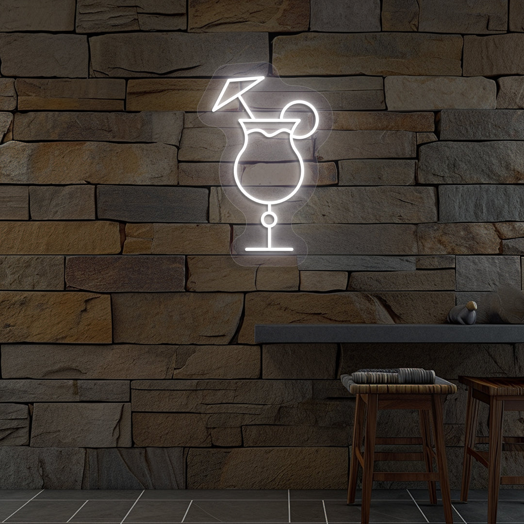 Image of a "cocktail glass with a lime" neon sign glowing on wall in white color.