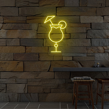 Stylish "cocktail glass with a lime" neon sign glowing yellow on wall.