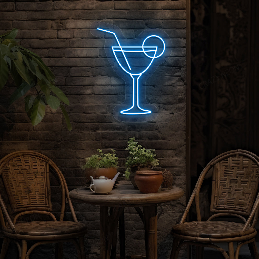 Image of a cocktail LED neon sign glowing on a bar wall in ice blue color.