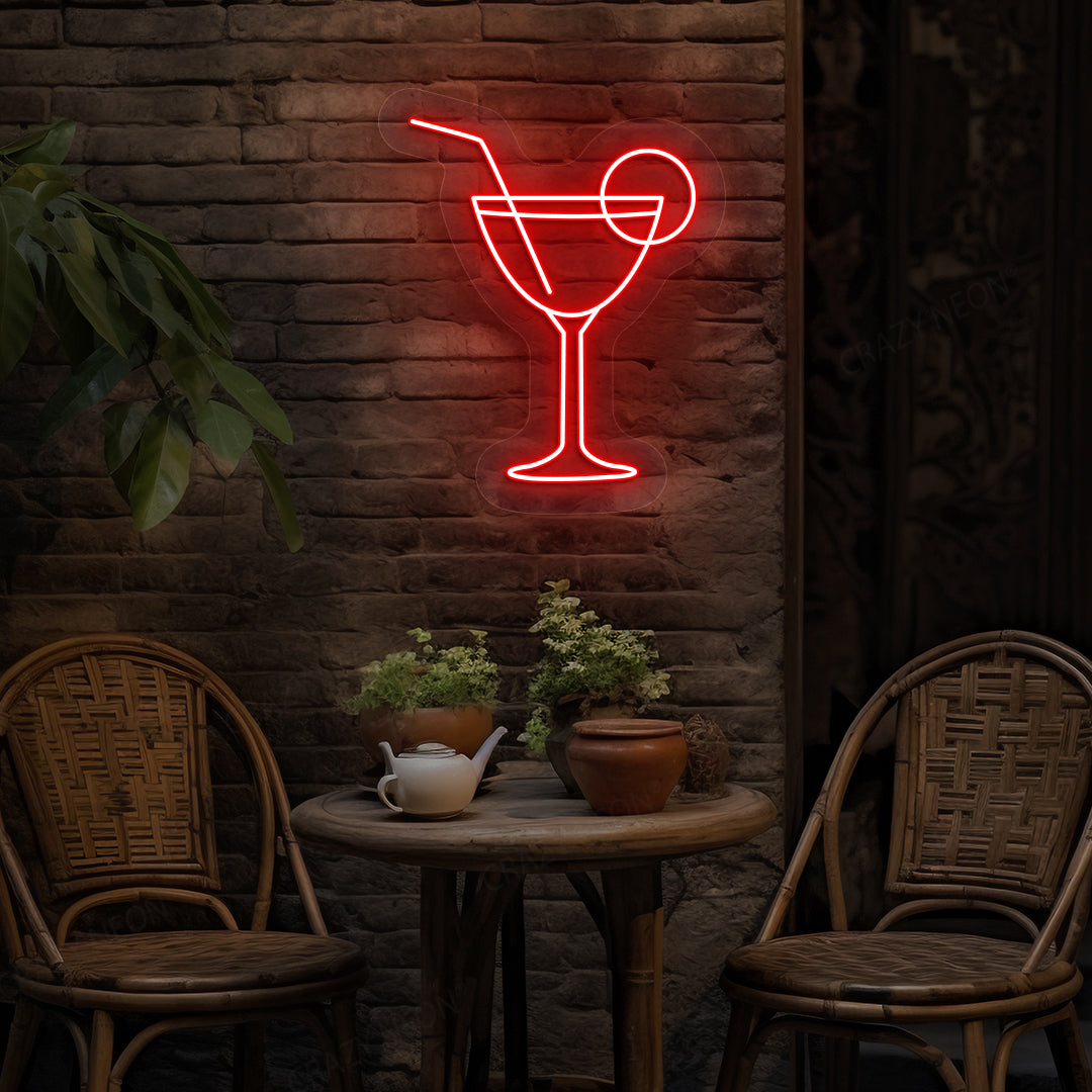 Image of a cocktail LED neon sign glowing on a bar wall in red color.