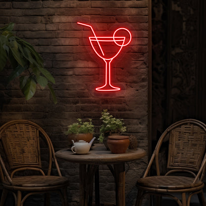 Image of a cocktail LED neon sign glowing on a bar wall in red color.
