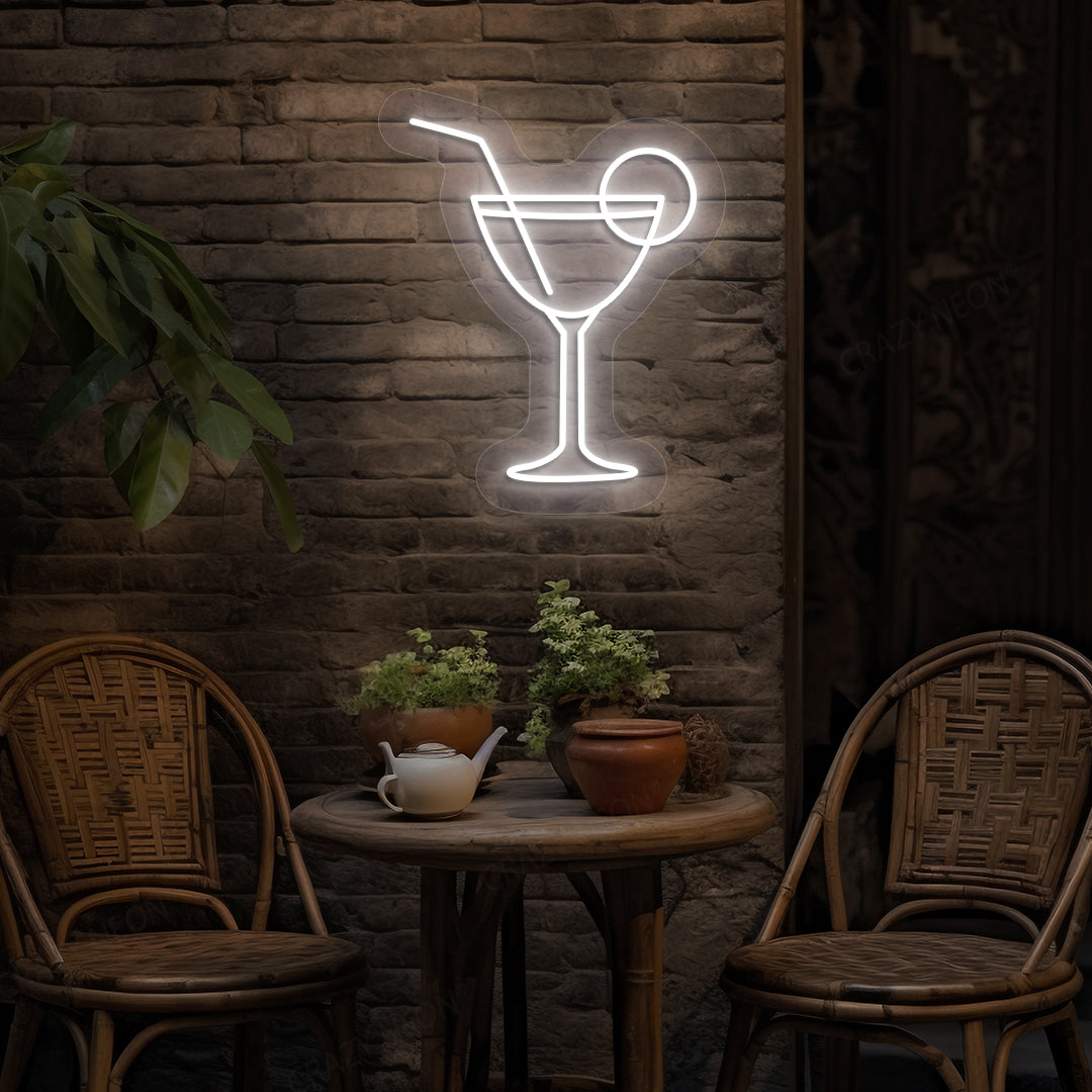 Image of a cocktail LED neon sign glowing on a bar wall in white color.