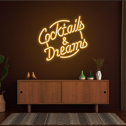 Orange LED cocktail and dreams neon signs are hanging on the bar wall. Perfect for bars, cocktail lounges, and home bar setups.