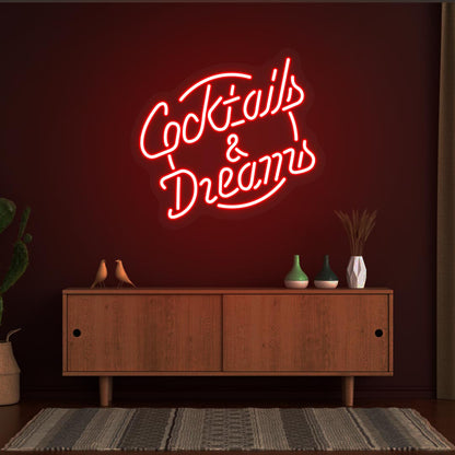 Decorative cocktail and dreams LED neon sign glowing red on the wall.