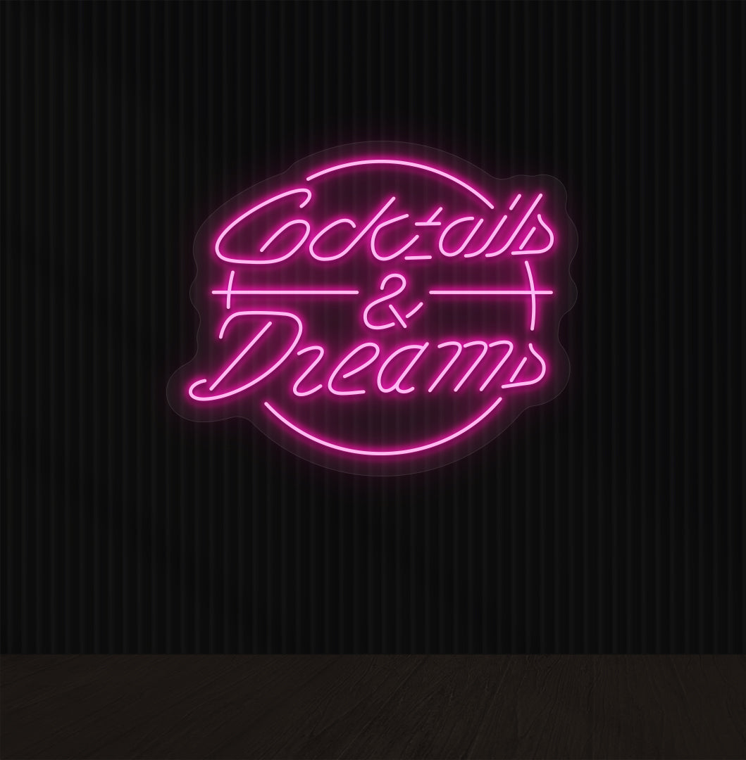 Image of a cocktails and dream LED neon sign on bar wall in pink color.