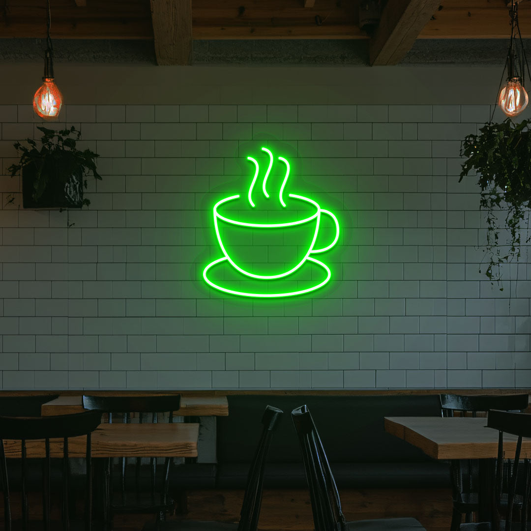 Image of a coffee mug neon sign mounted on a cafe wall in green color.