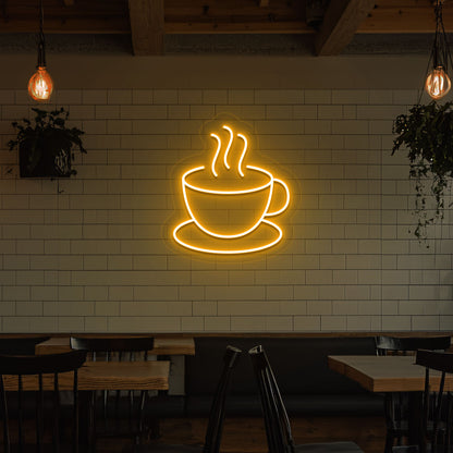 Image of a coffee mug neon sign mounted on a cafe wall in orange color.