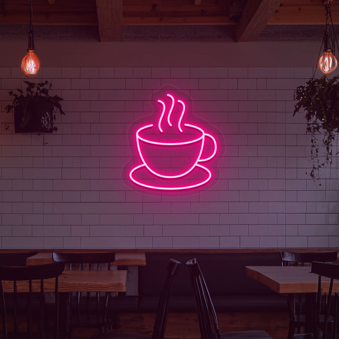 Stylish coffee mug neon sign in pink LED on cafe interior wall.