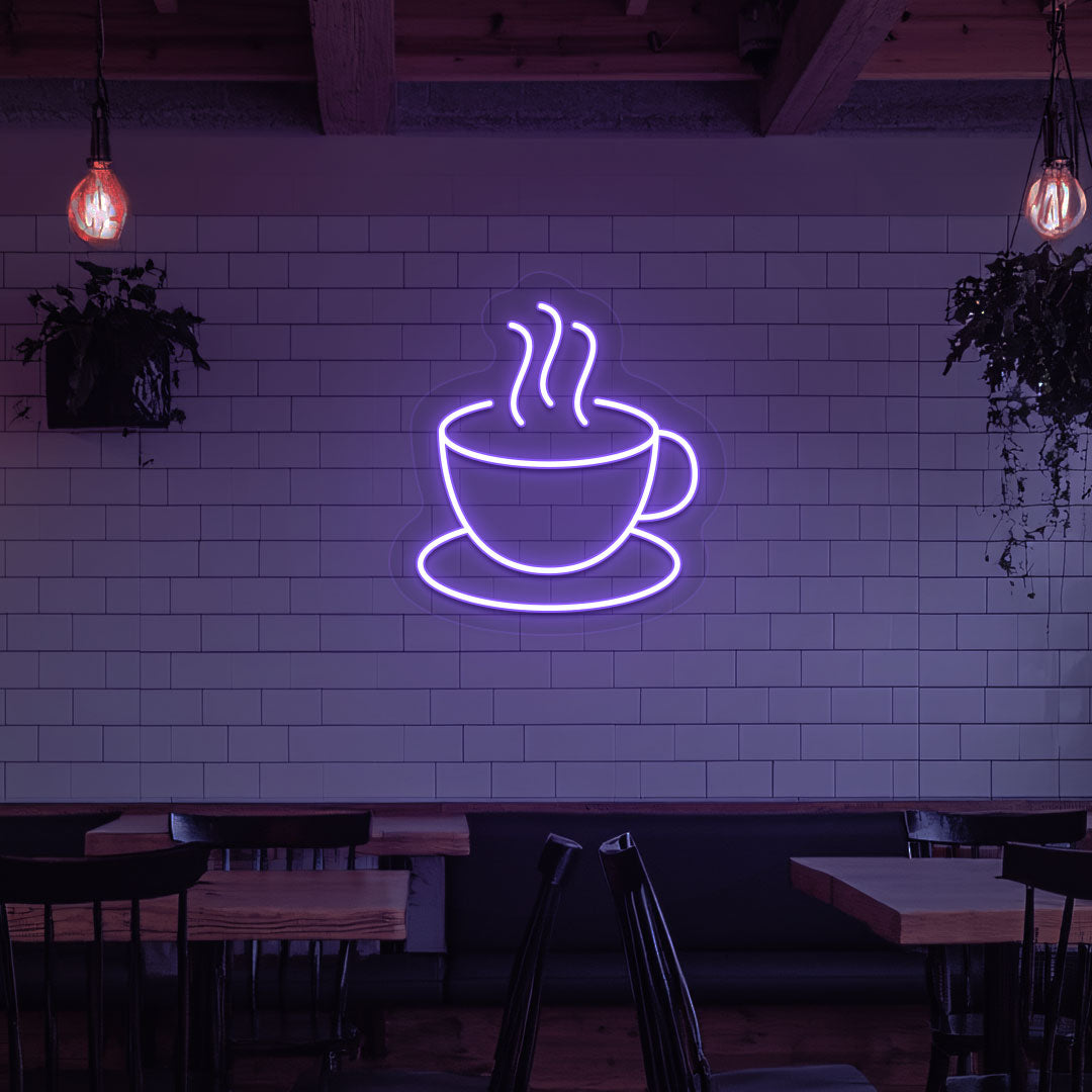 A bright purple LED coffee mug neon sign is mounted on the cafe wall. Perfect for coffee shops, bakeries, home coffee corners, and restaurants.