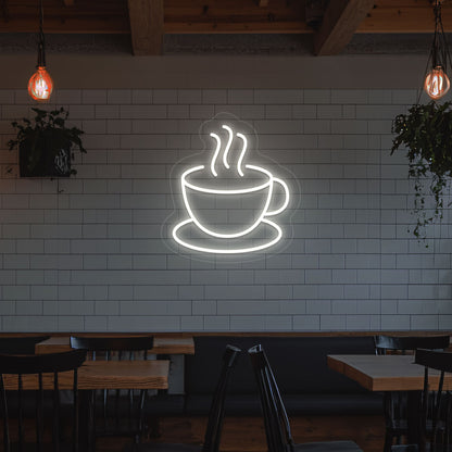 A bright white LED coffee mug neon sign is mounted on the cafe wall. Perfect for coffee shops, bakeries, home coffee corners, and restaurants.