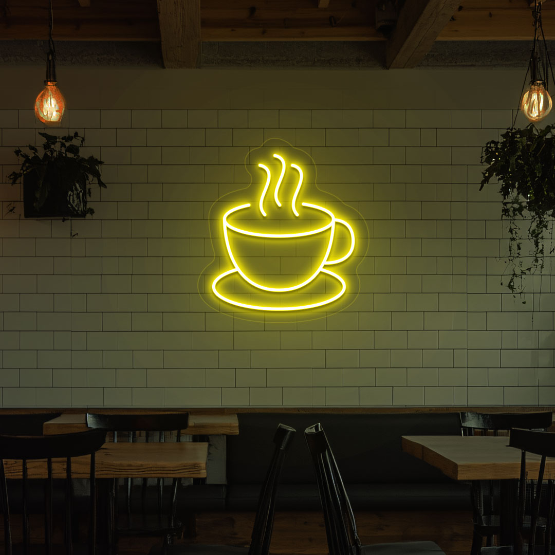 Image of a coffee mug neon sign mounted on a cafe wall in yellow color.