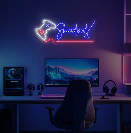 Personalized gamer name neon sign with controller mounted on decorative wall in blue color.