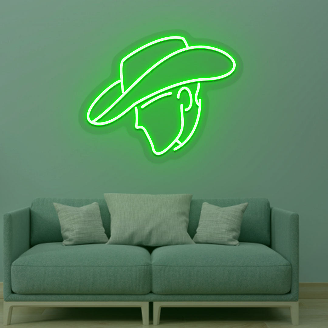 Western style cowboy green LED neon sign mounted on a living room wall.