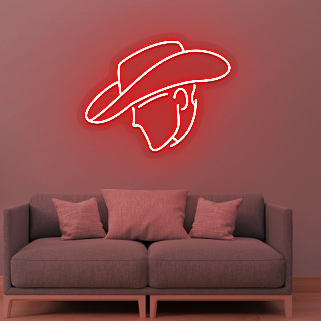 Image of a cowboy face neon sign glowing on a living room wall in red color.
