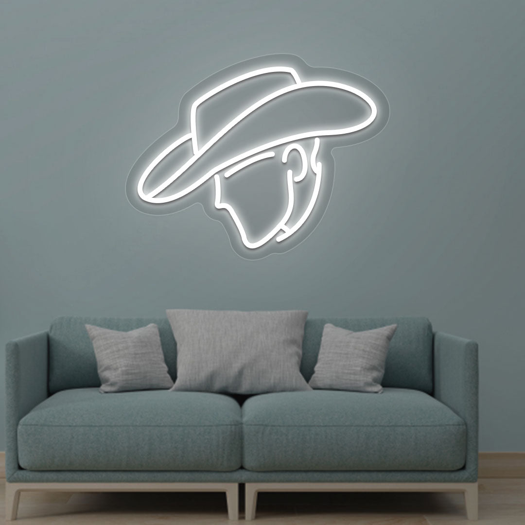Image of a cowboy face neon sign glowing on a living room wall in white color.