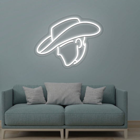 Image of a cowboy face neon sign glowing on a living room wall in white color.