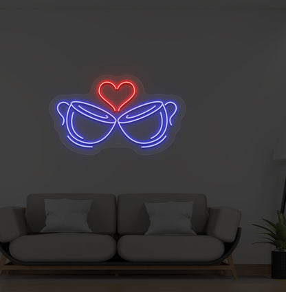Image of stylish cup heart LED neon sign glowing blue on wall.