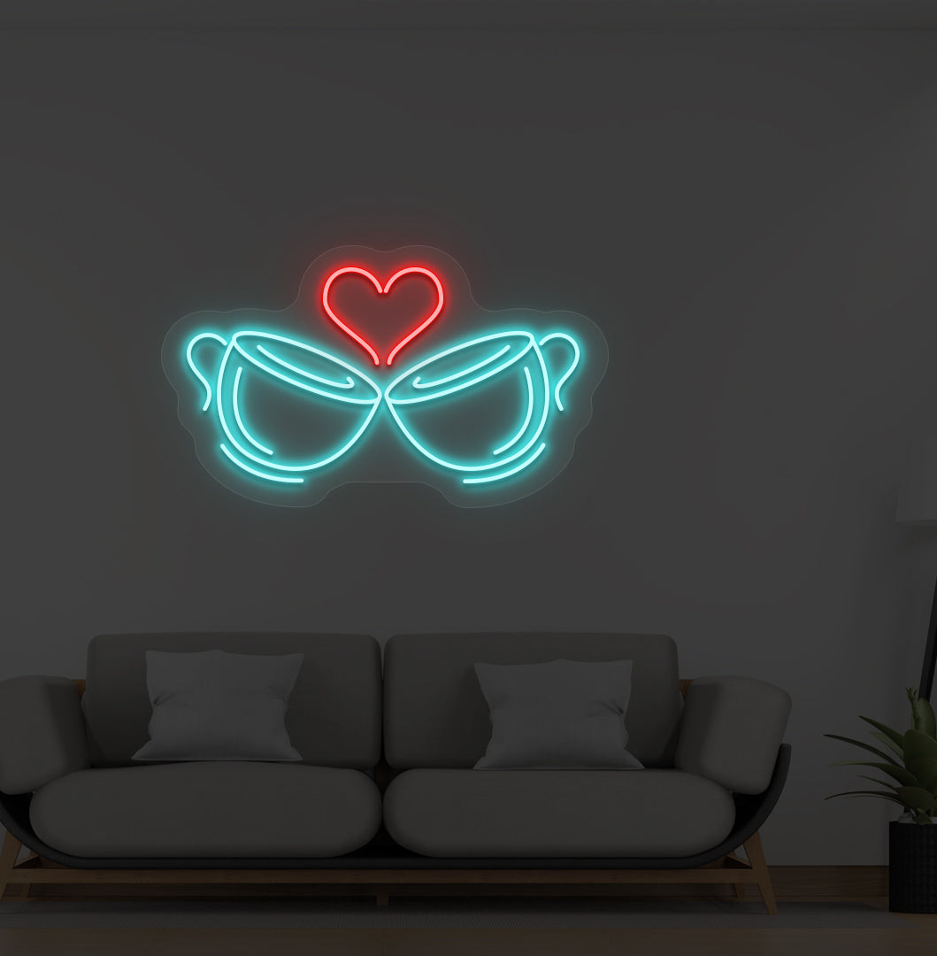 Image of stylish cup heart LED neon sign glowing ice blue on wall.