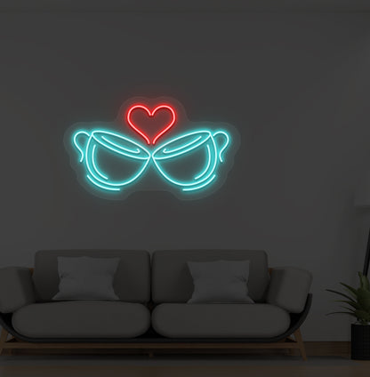 Image of stylish cup heart LED neon sign glowing ice blue on wall.