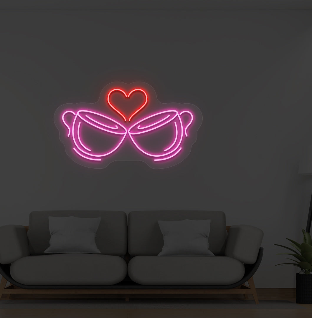 Image of stylish cup heart LED neon sign glowing pink on wall.
