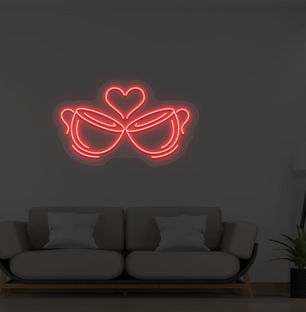 Image of stylish cup heart LED neon sign glowing red on wall.