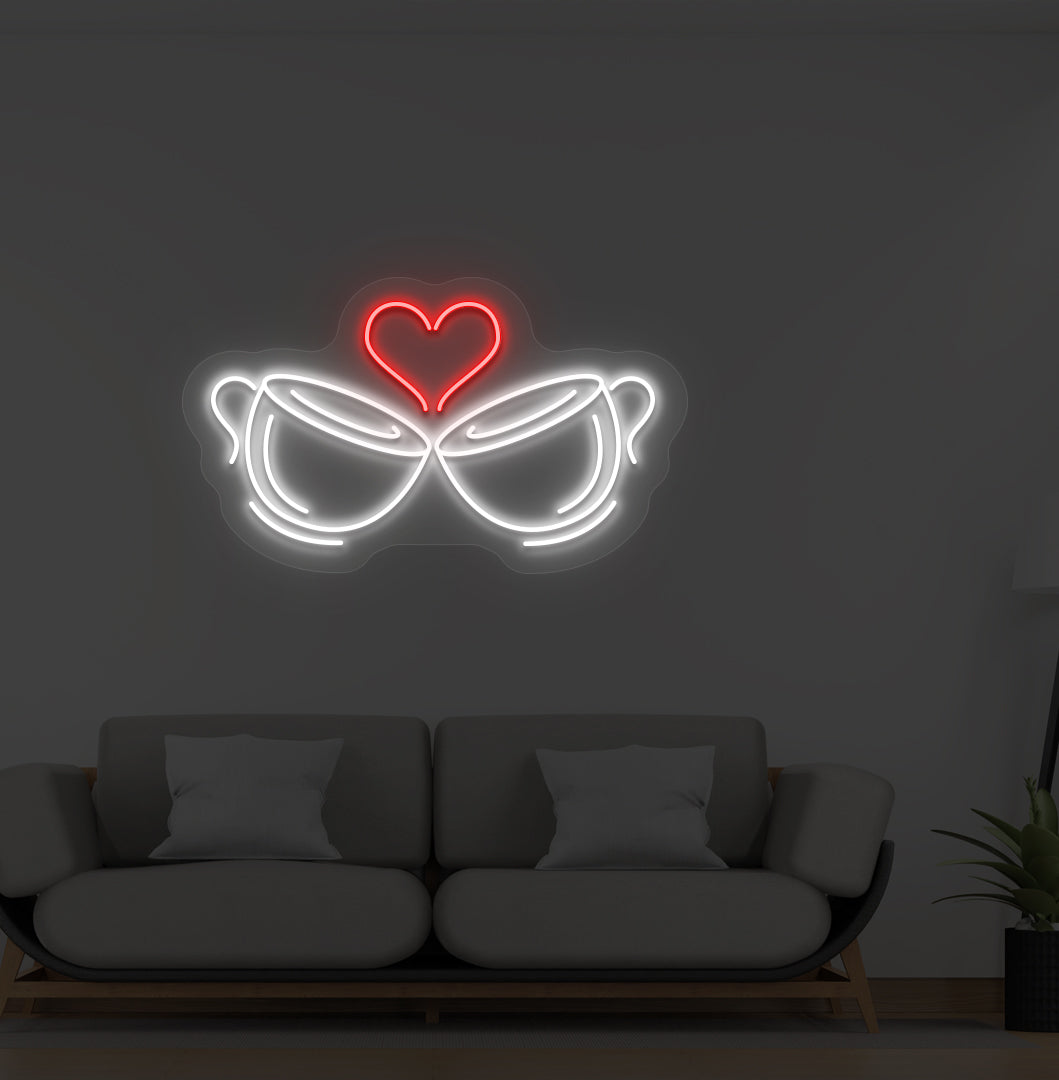 Image of stylish cup heart LED neon sign glowing white on wall.