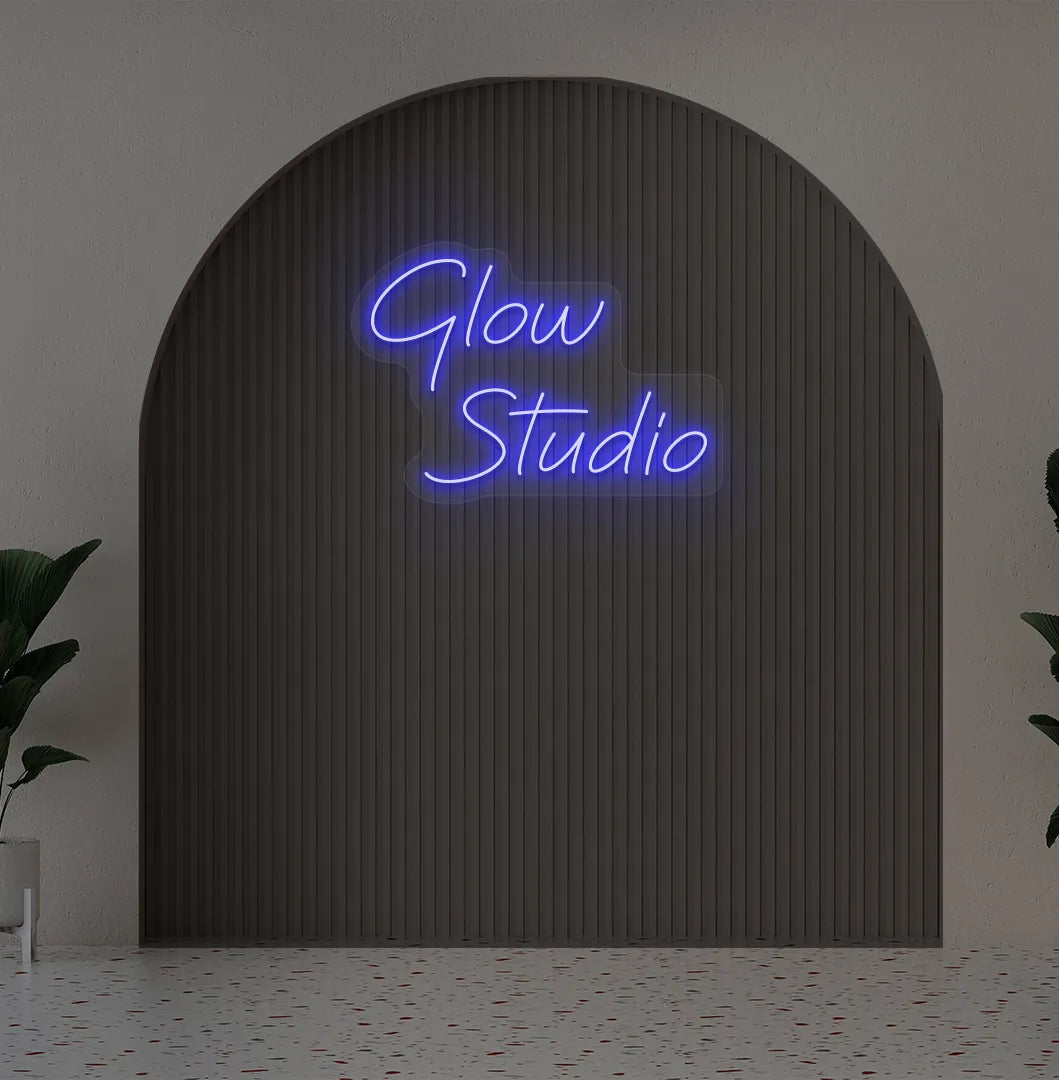 Personalized business name neon sign in blue color mounted on aesthetic wall.