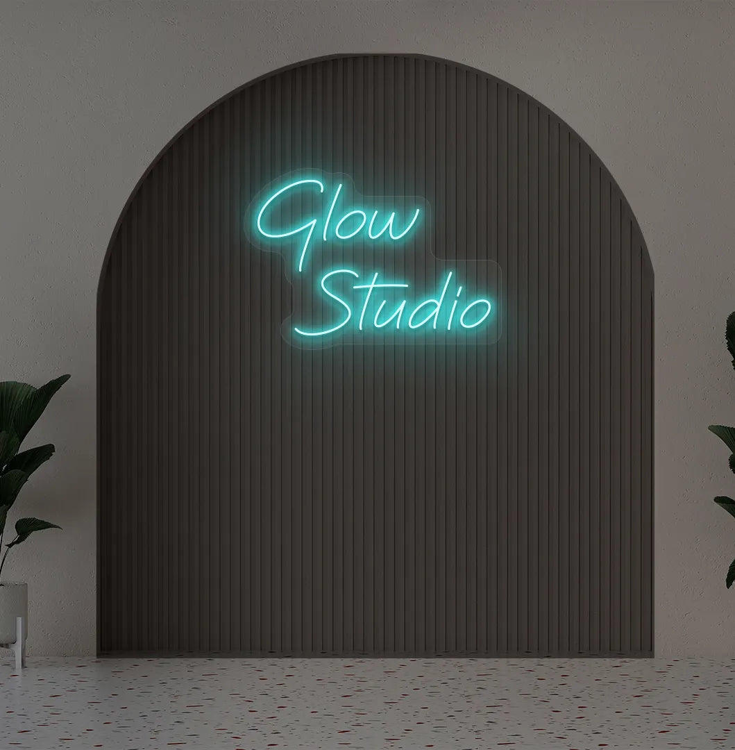 Personalized business name neon sign in ice blue color mounted on aesthetic wall.