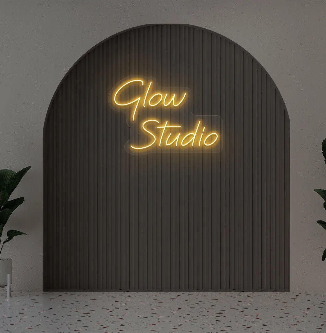 Stylish personalized business name neon sign mounted on aesthetic wall in orange color.