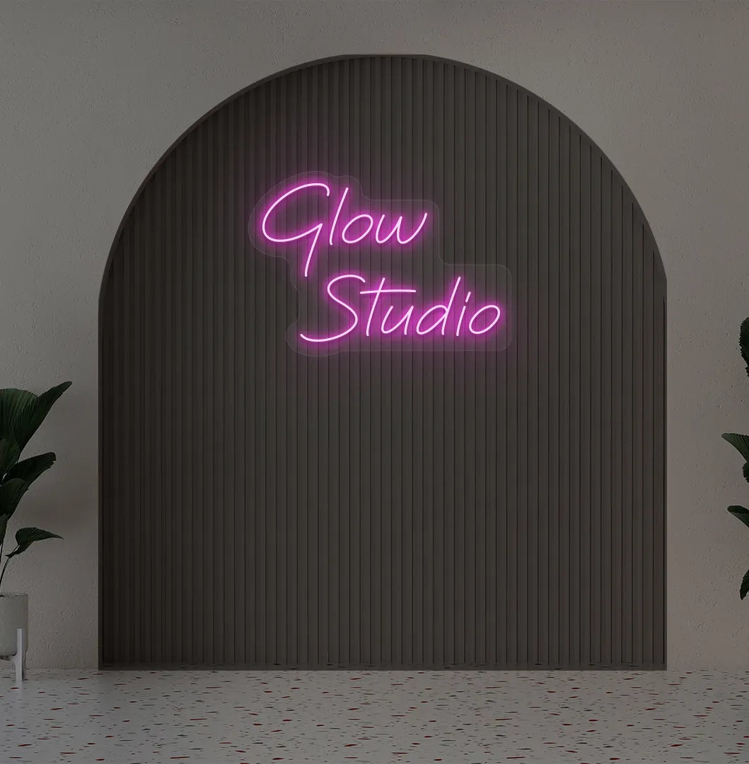 Stylish personalized business name neon sign mounted on aesthetic wall in purple color.
