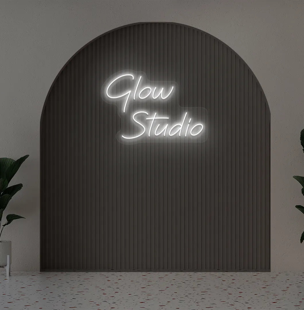 Personalized business name neon sign in white color mounted on aesthetic wall.