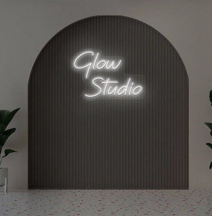 Personalized business name neon sign in white color mounted on aesthetic wall.