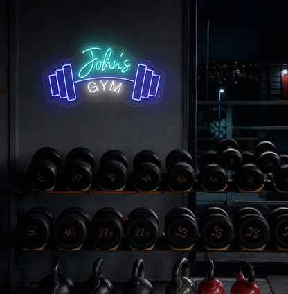 Stylish personalized gym name neon sign with dumbbell mounted on aesthetic wall in ice blue color.