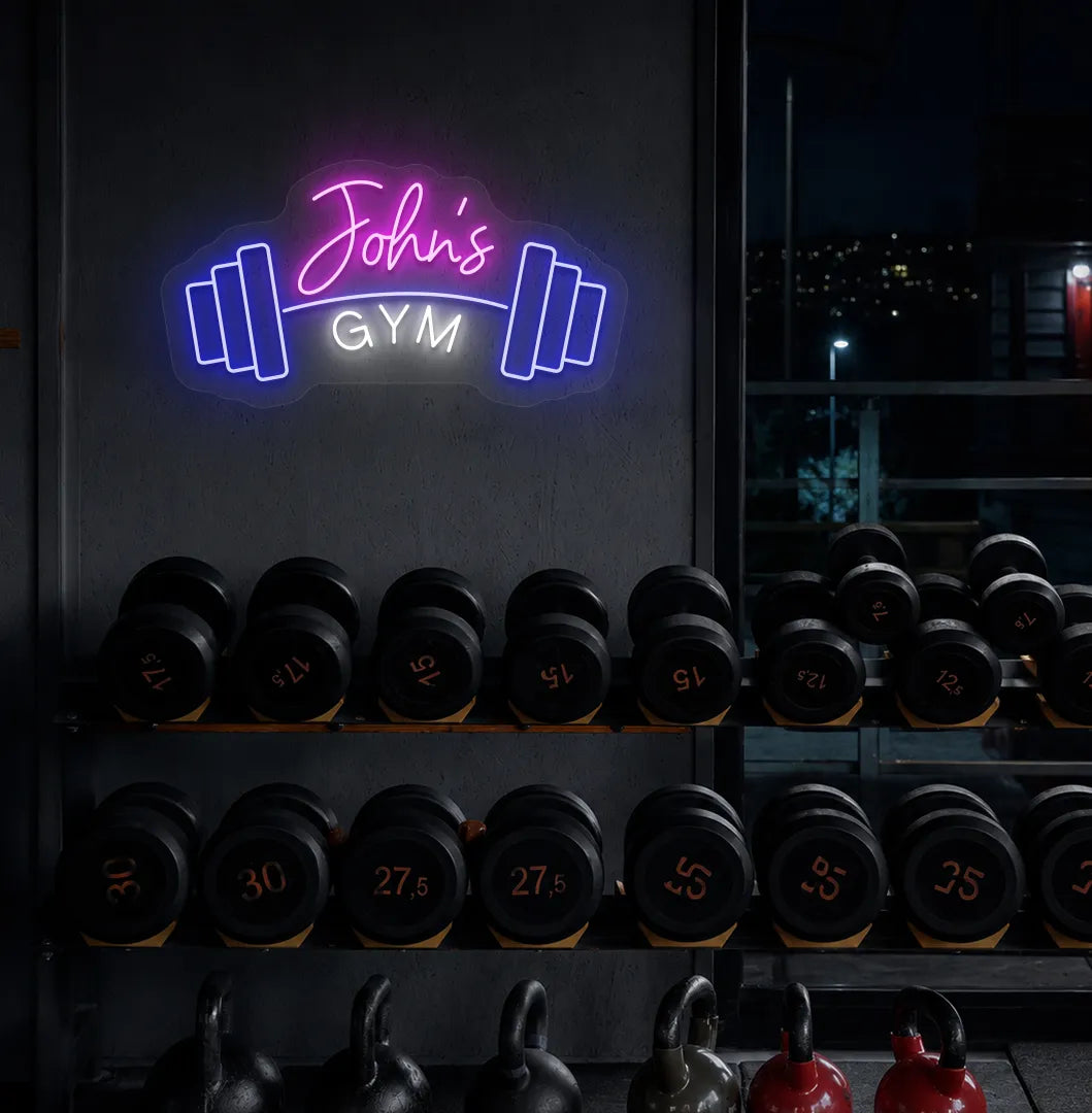 Stylish personalized gym name neon sign with dumbbell mounted on aesthetic wall in pink color.