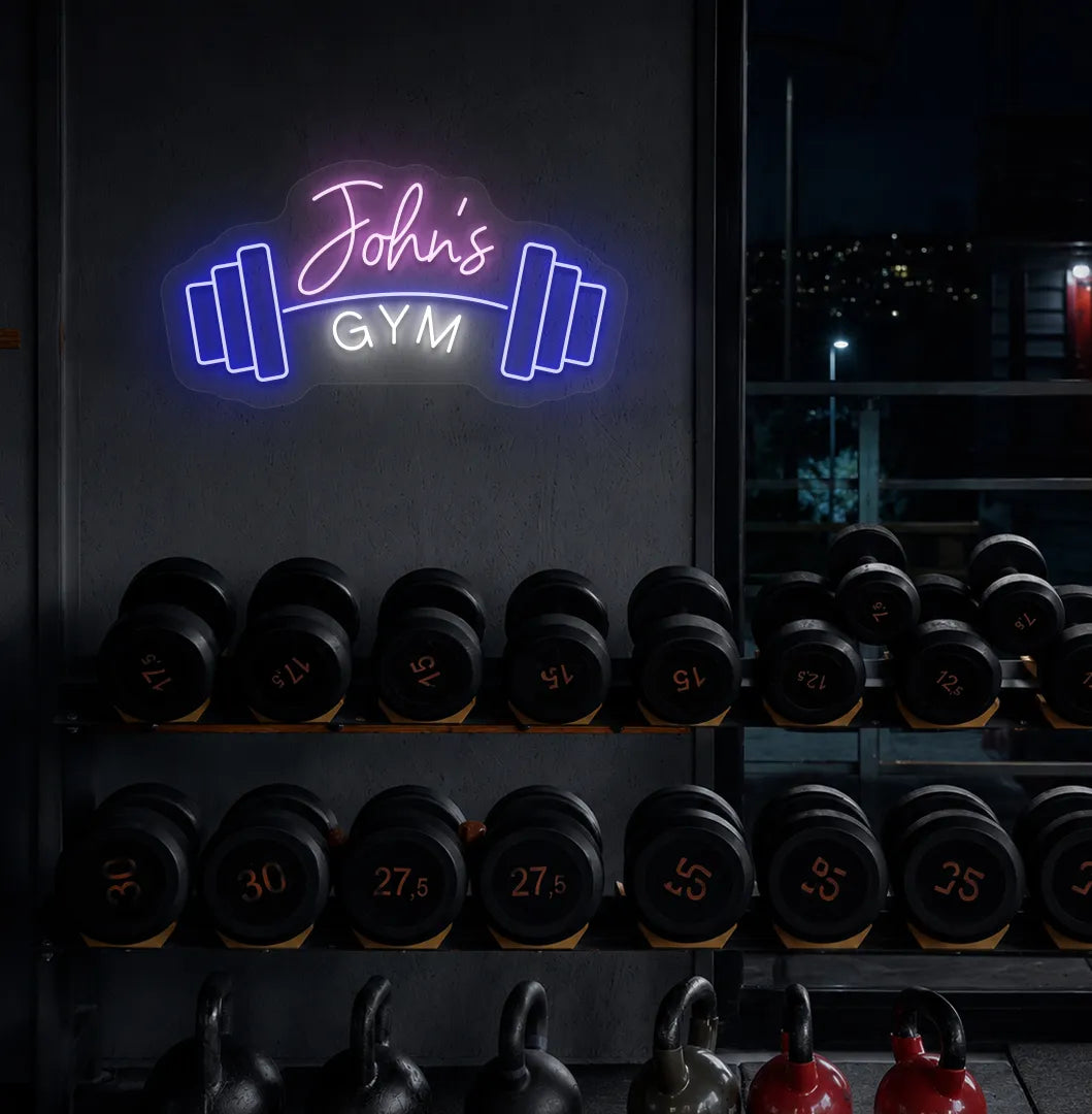Custom GYM Name with Dumbbell LED neon sign mounted on modern fitness studio wall in purple color.