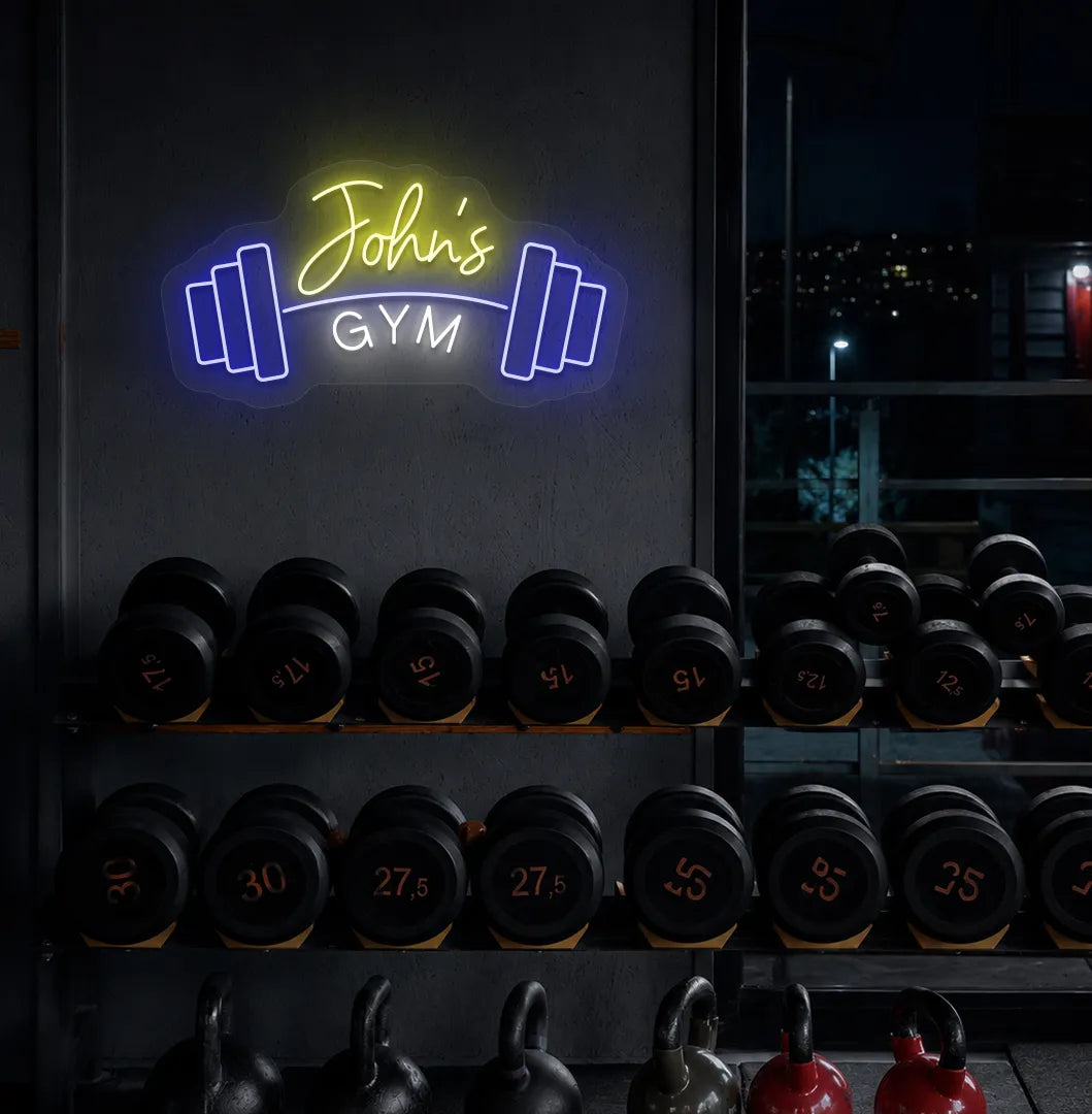 Custom GYM Name with Dumbbell LED neon sign mounted on modern fitness studio wall in yellow color.
