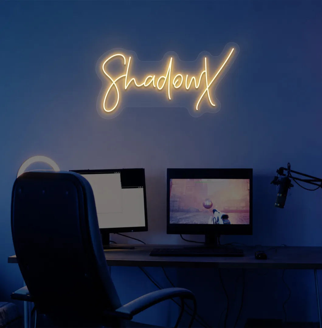Image of a stylish personalized gamer tag neon sign mounted on decorative wall in orange color.