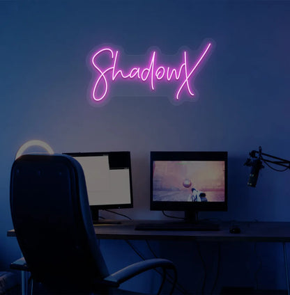 Image of a stylish personalized gamer tag neon sign mounted on decorative wall in purple color.